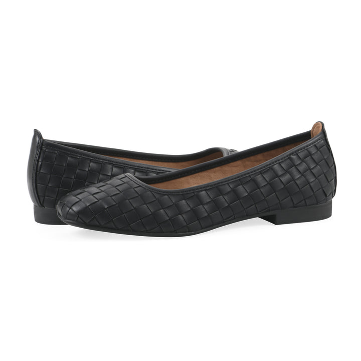 Angle view of a pair of black faux leather, woven pattern flats with a black sole