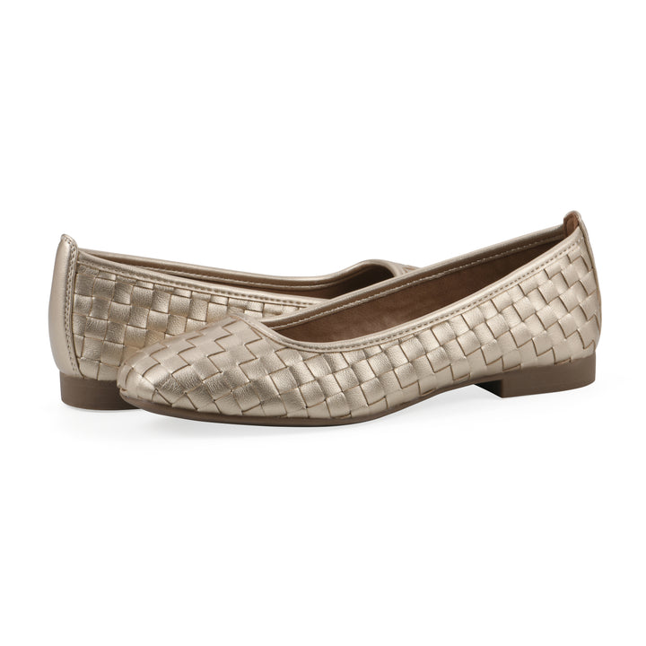 Angle view of a pair of light gold faux leather, woven pattern flats with a brown sole