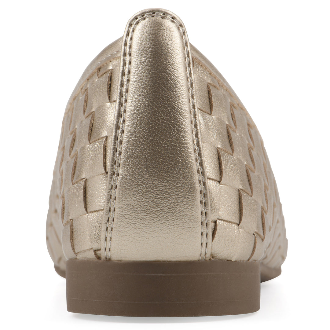 Rear view of a light gold faux leather, woven pattern flat with a brown sole