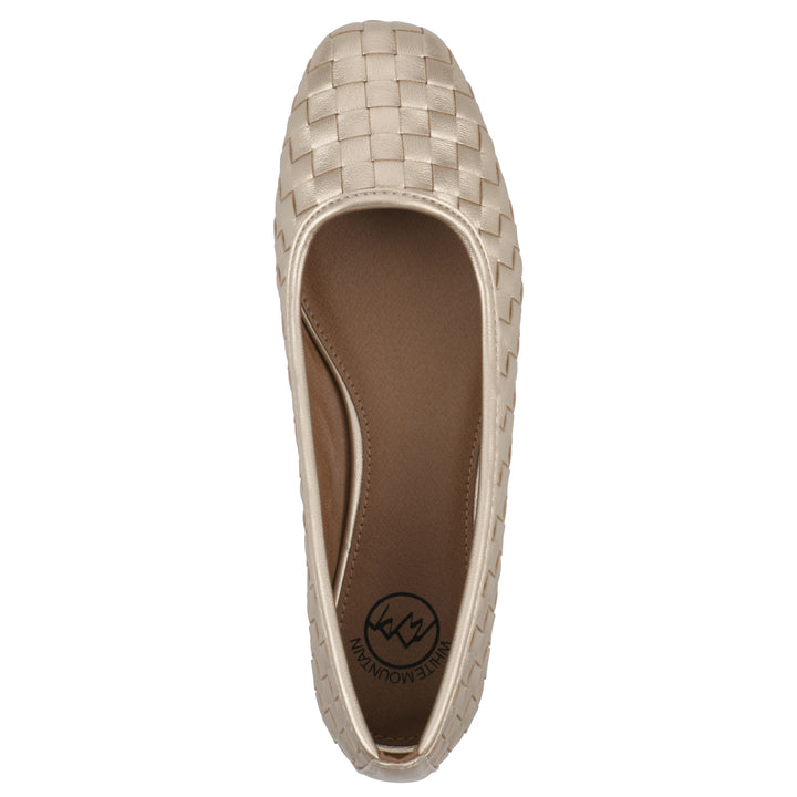 Top view of a light gold faux leather, woven pattern flat with a brown sole