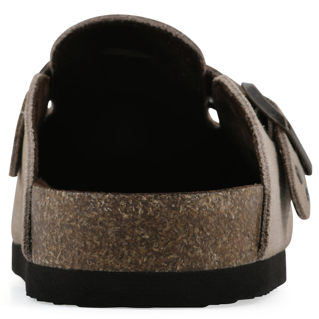 Rear view of a tan suede backless clog with an adjustable buckle strap with stud and eyelet detailing and a black sole