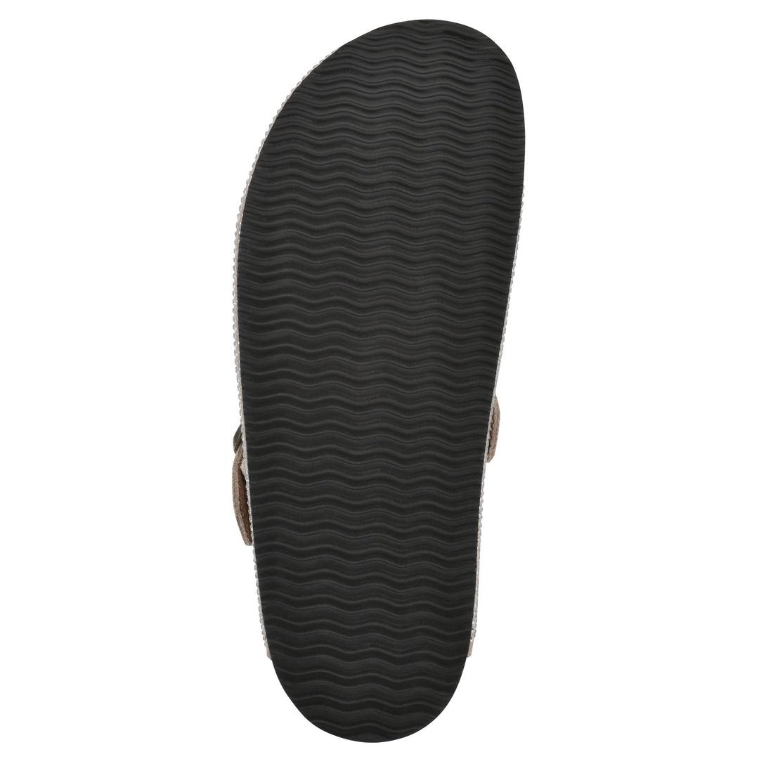 Sole view of a tan micro-sequined backless clog with adjustable buckle strap and black sole
