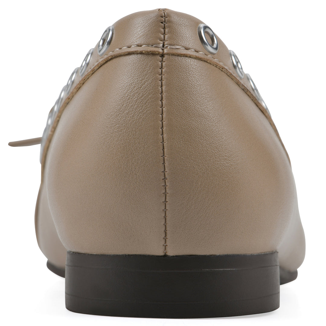 Rear view of a tan faux leather flat with small, centered bow, silver metal grommet lining and a black sole