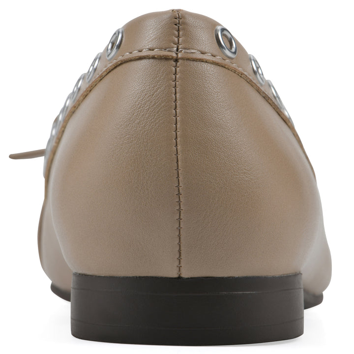 Rear view of a tan faux leather flat with small, centered bow, silver metal grommet lining and a black sole