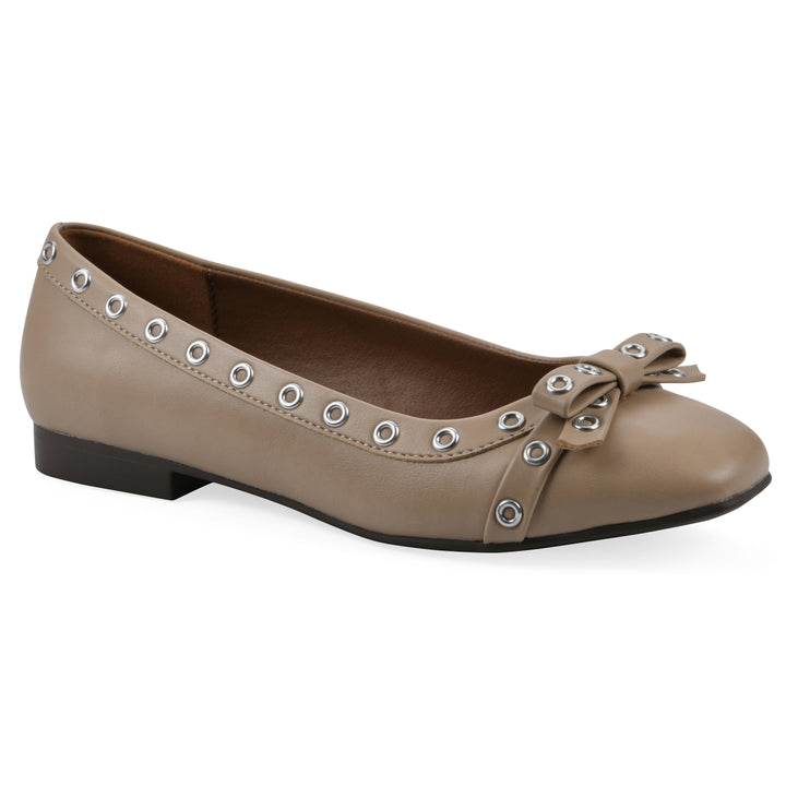 Angle view of a tan faux leather flat with small, centered bow, silver metal grommet lining and a black sole