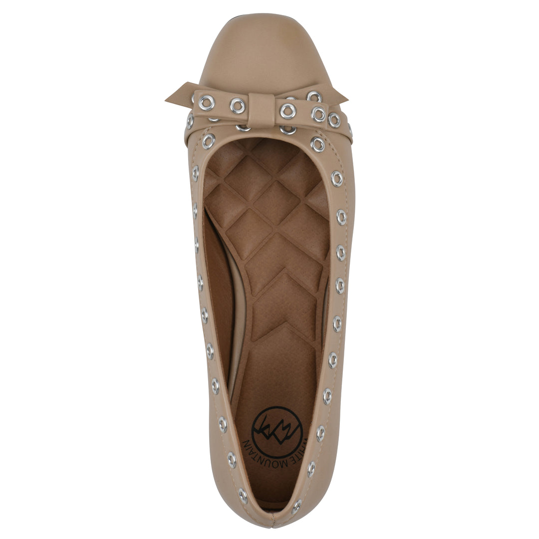 Top view of a tan faux leather flat with small, centered bow, silver metal grommet lining and a black sole