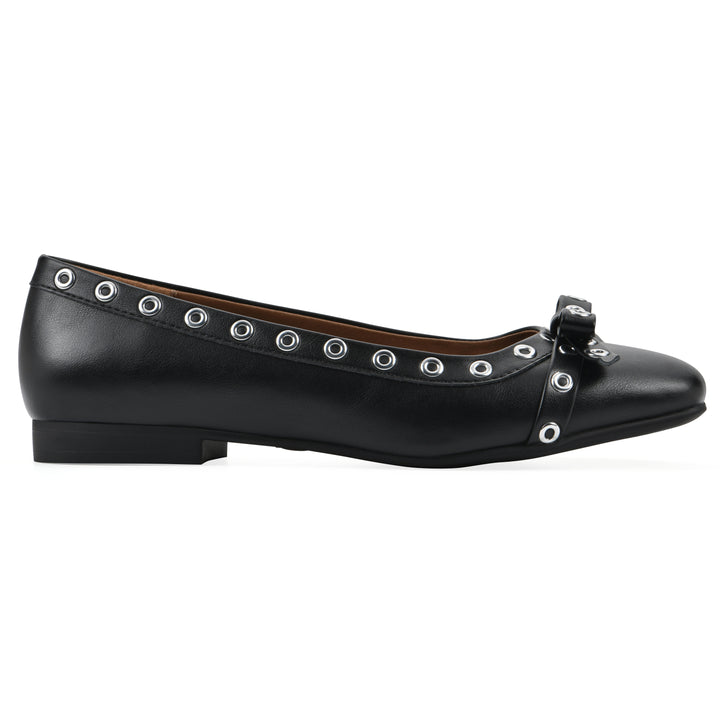 Side view of a black faux leather flat with small, centered bow, silver metal grommet lining and a black sole
