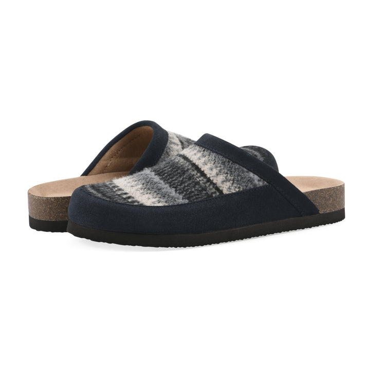 Angle view of a pair of black and white multi felt and suede backless clogs with a black sole