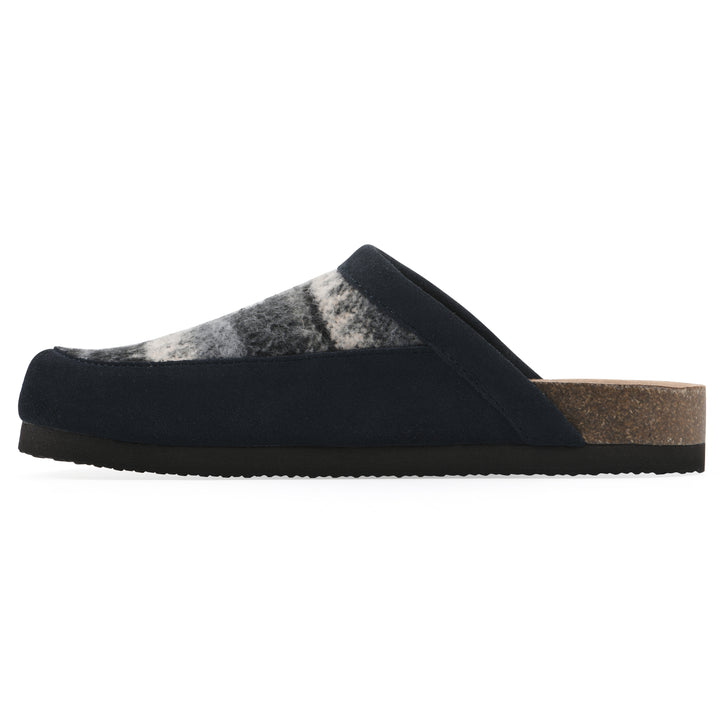 Side view of a black and white multi felt and suede backless clog with a black sole