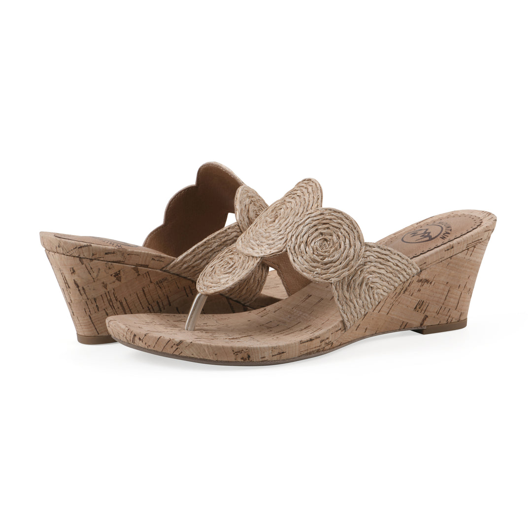 Angle view of a pair of cork print wedge sandal with natural cream raffia thong design 
