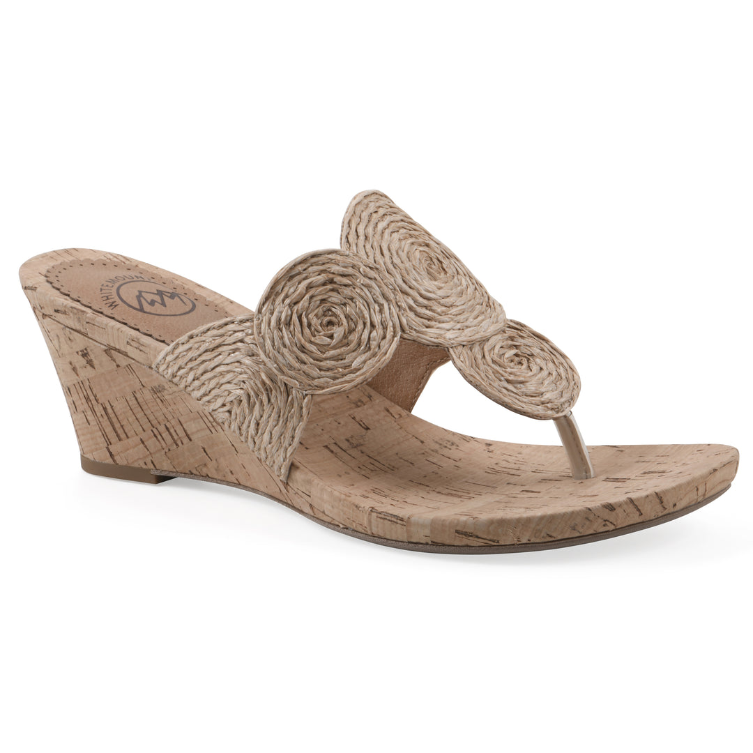 Angle view of a cork print wedge sandal with natural cream raffia thong design 