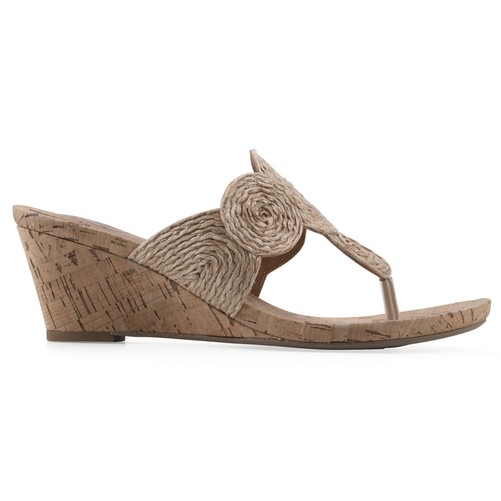 Angle view of a cork print wedge sandal with natural cream raffia thong design 