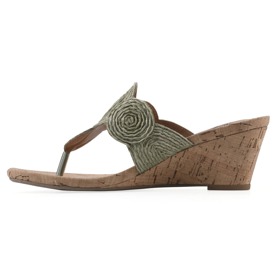 Side view of a cork print wedge sandal with green raffia thong design 