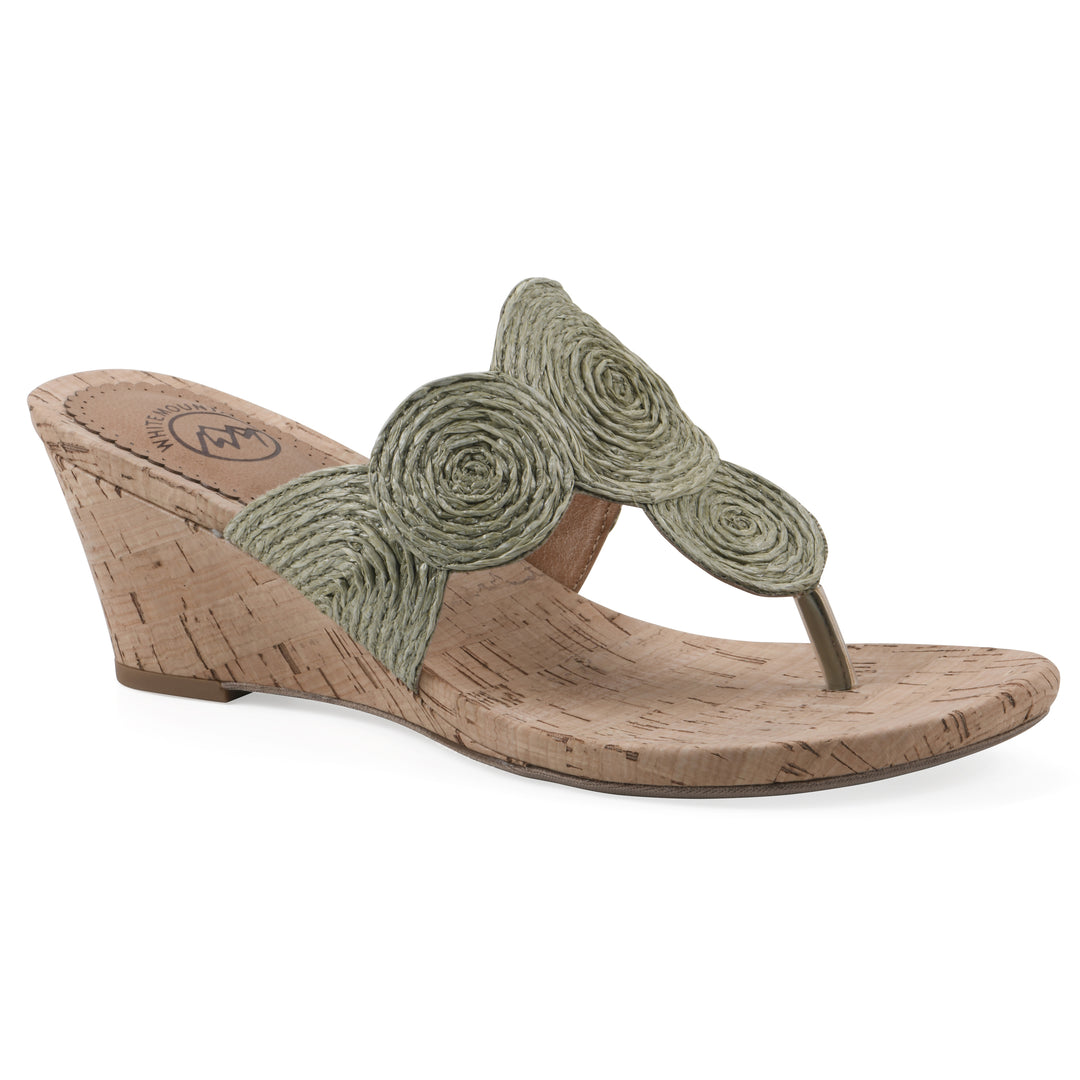 Angle view of a cork print wedge sandal with green raffia thong design 