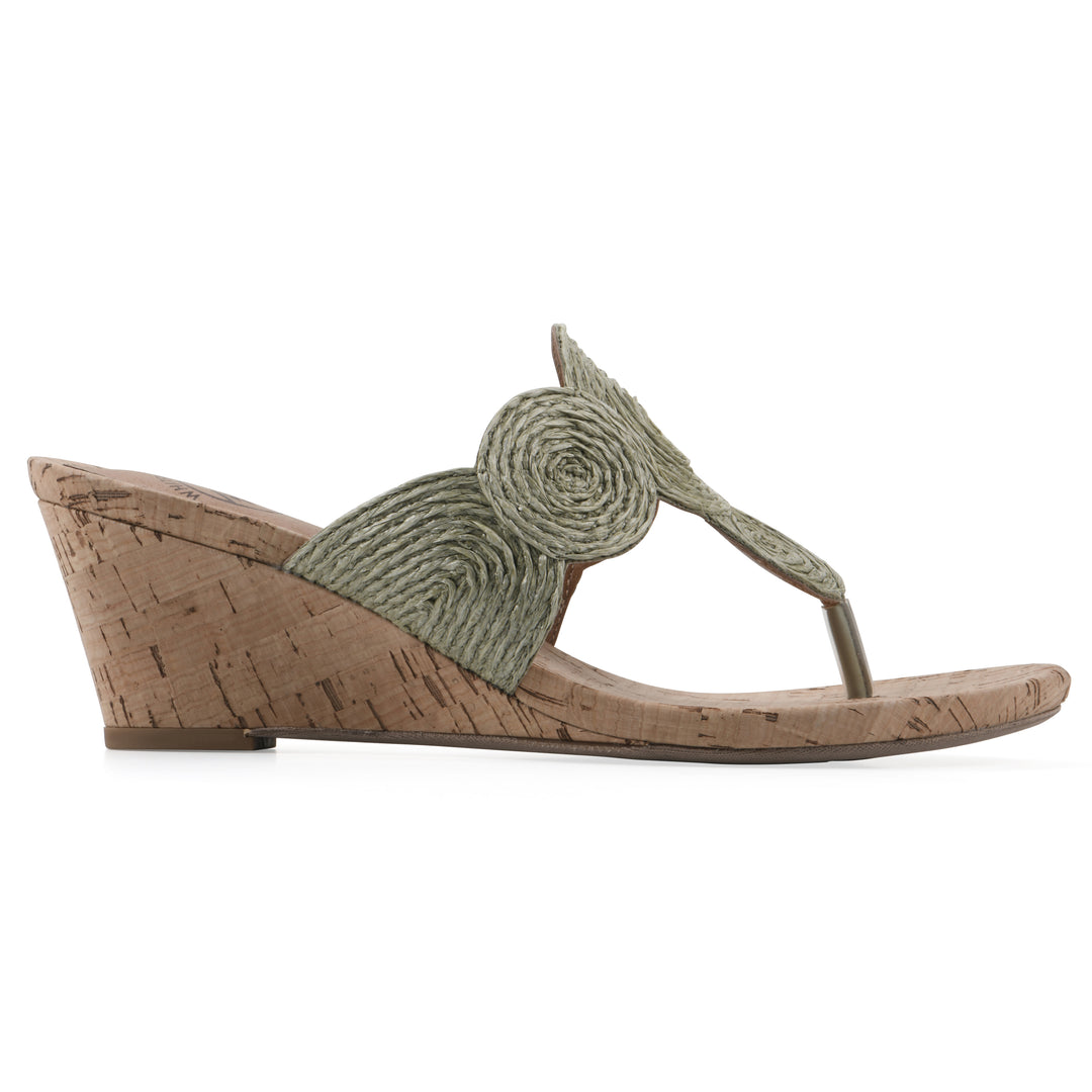 Side view of a cork print wedge sandal with green raffia thong design 