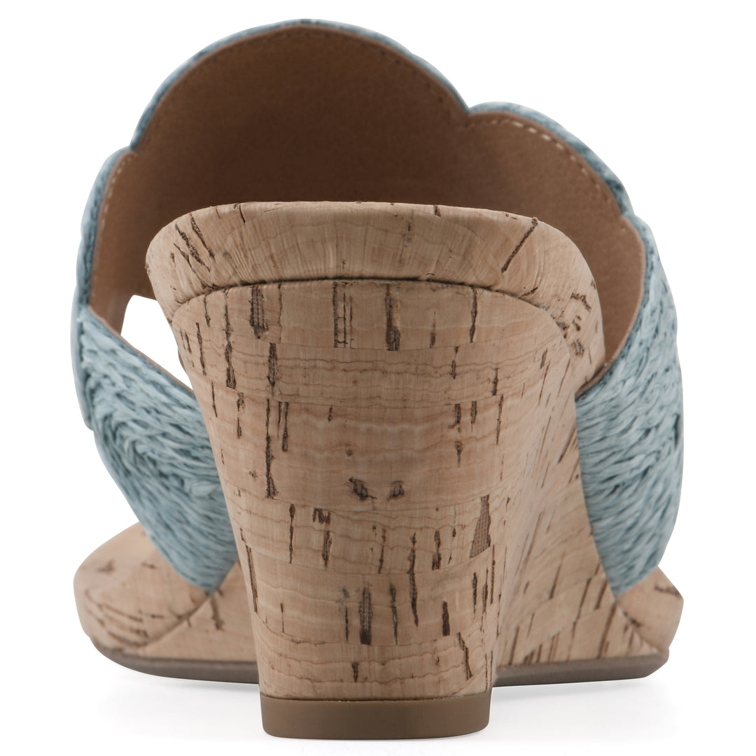 Rear view of a cork print wedge sandal with light blue raffia thong design 