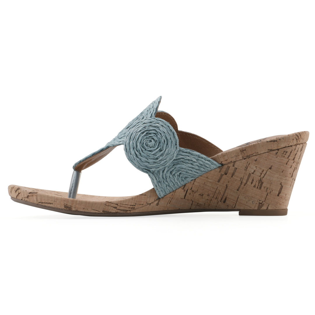 Side view of a cork print wedge sandal with light blue raffia thong design 