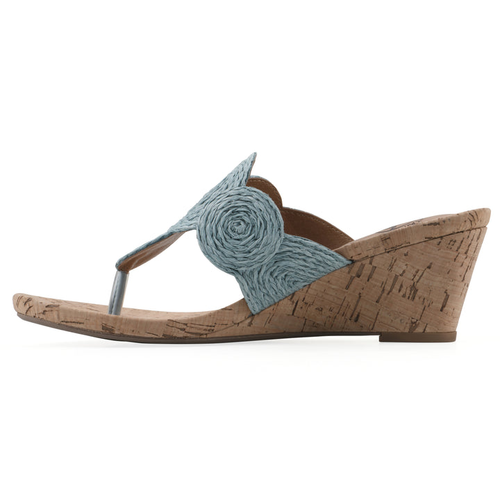 Side view of a cork print wedge sandal with light blue raffia thong design 