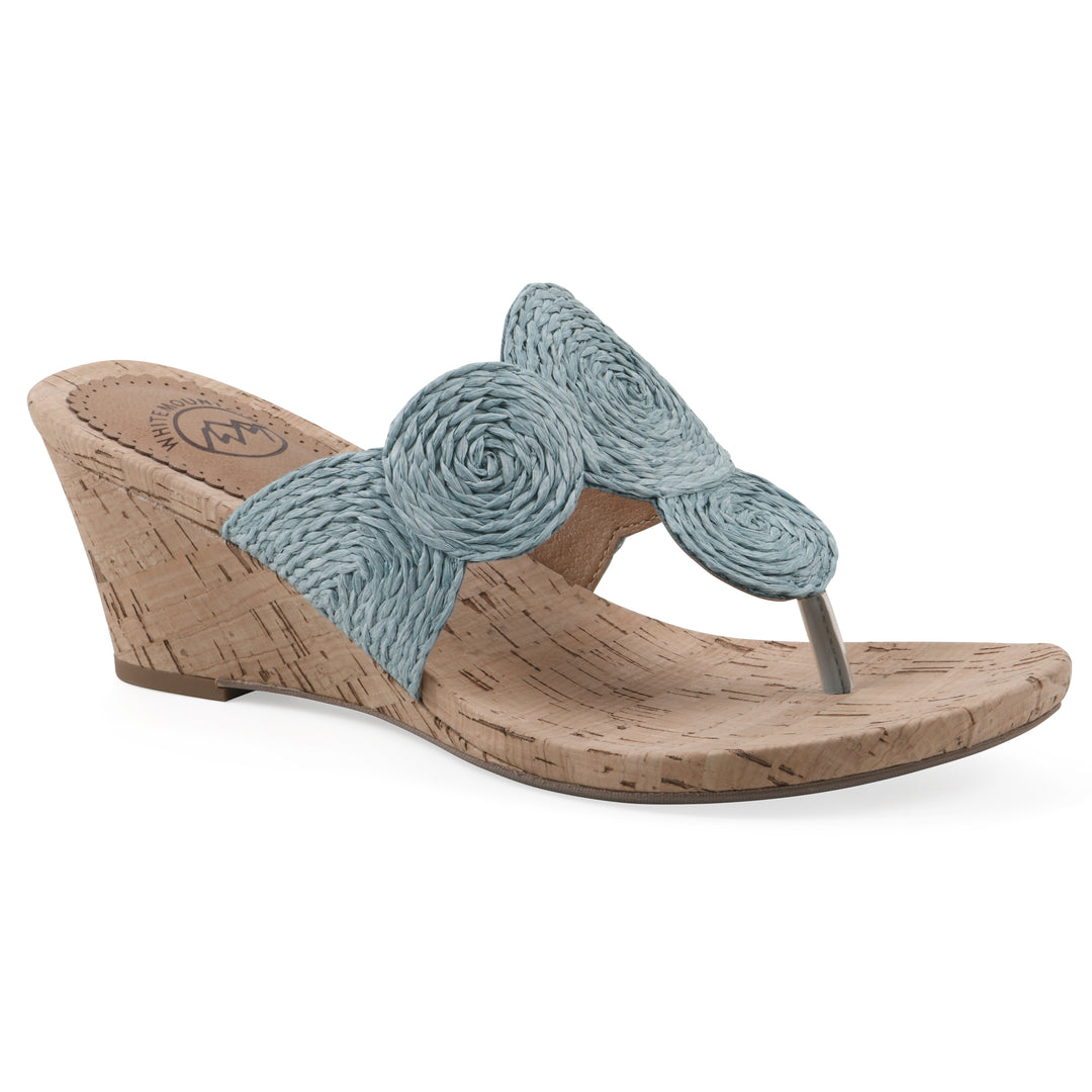Angle view of a cork print wedge sandal with light blue raffia thong design 