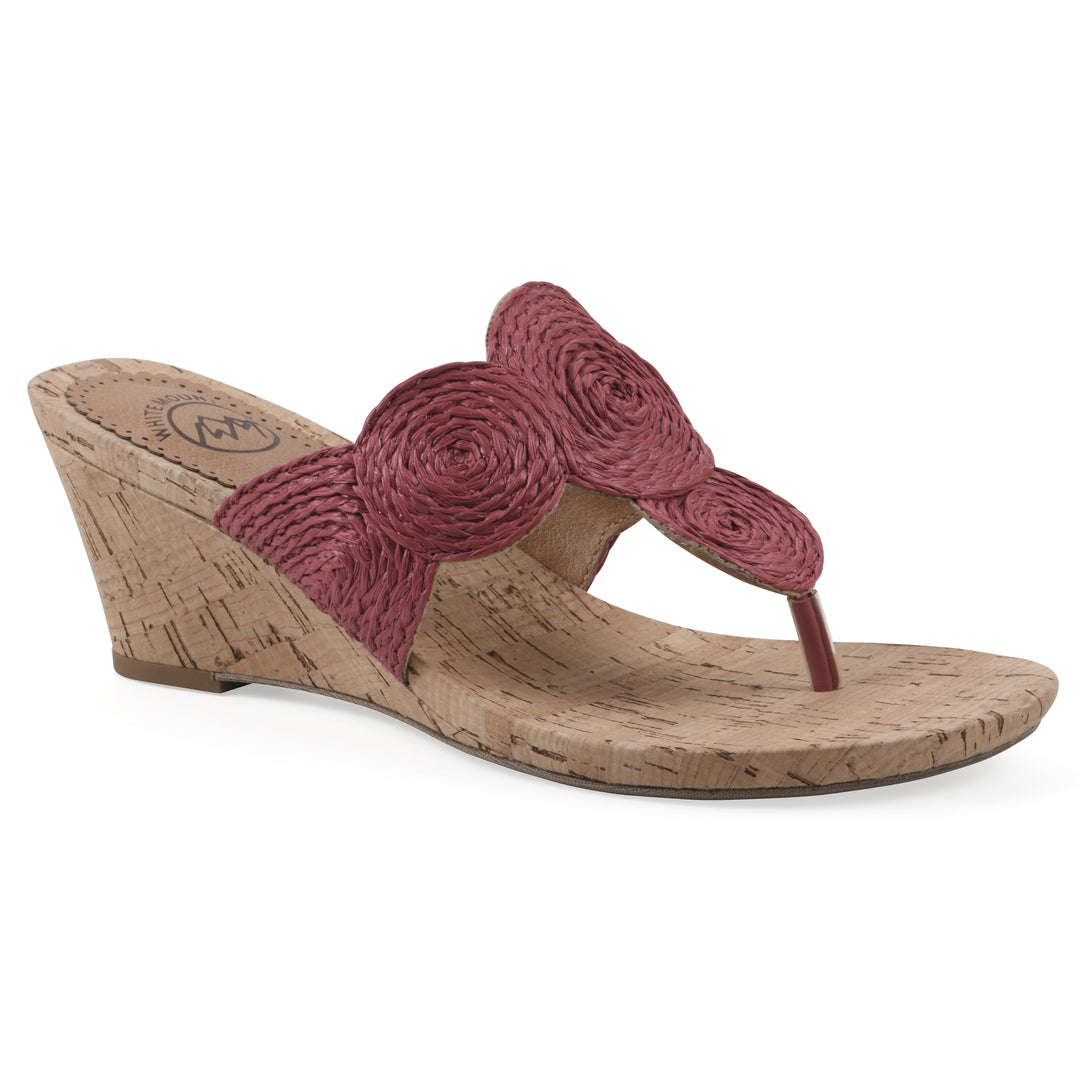 Angle view of a cork print wedge sandal with red raffia thong design 