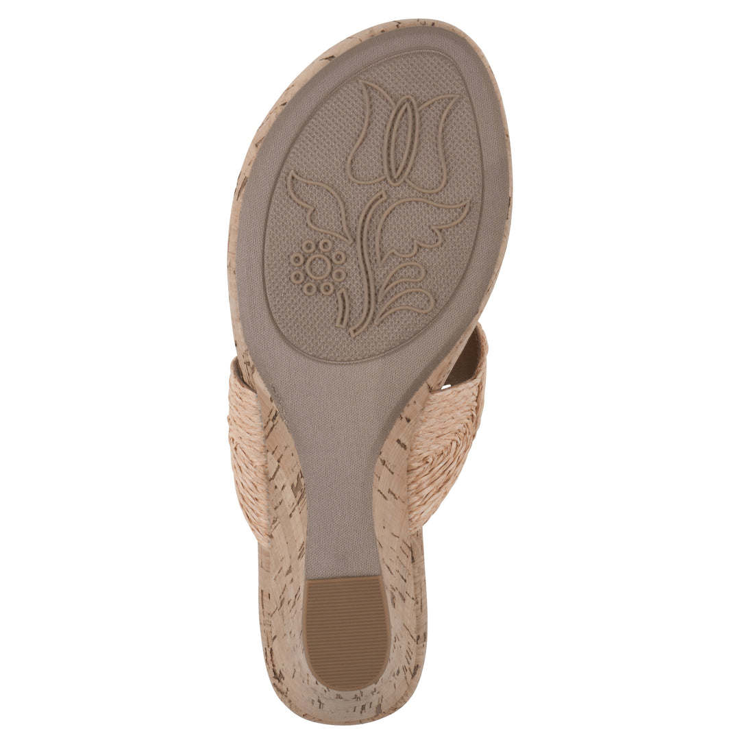 Sole view of a cork print wedge sandal with natural apricot color raffia thong design 