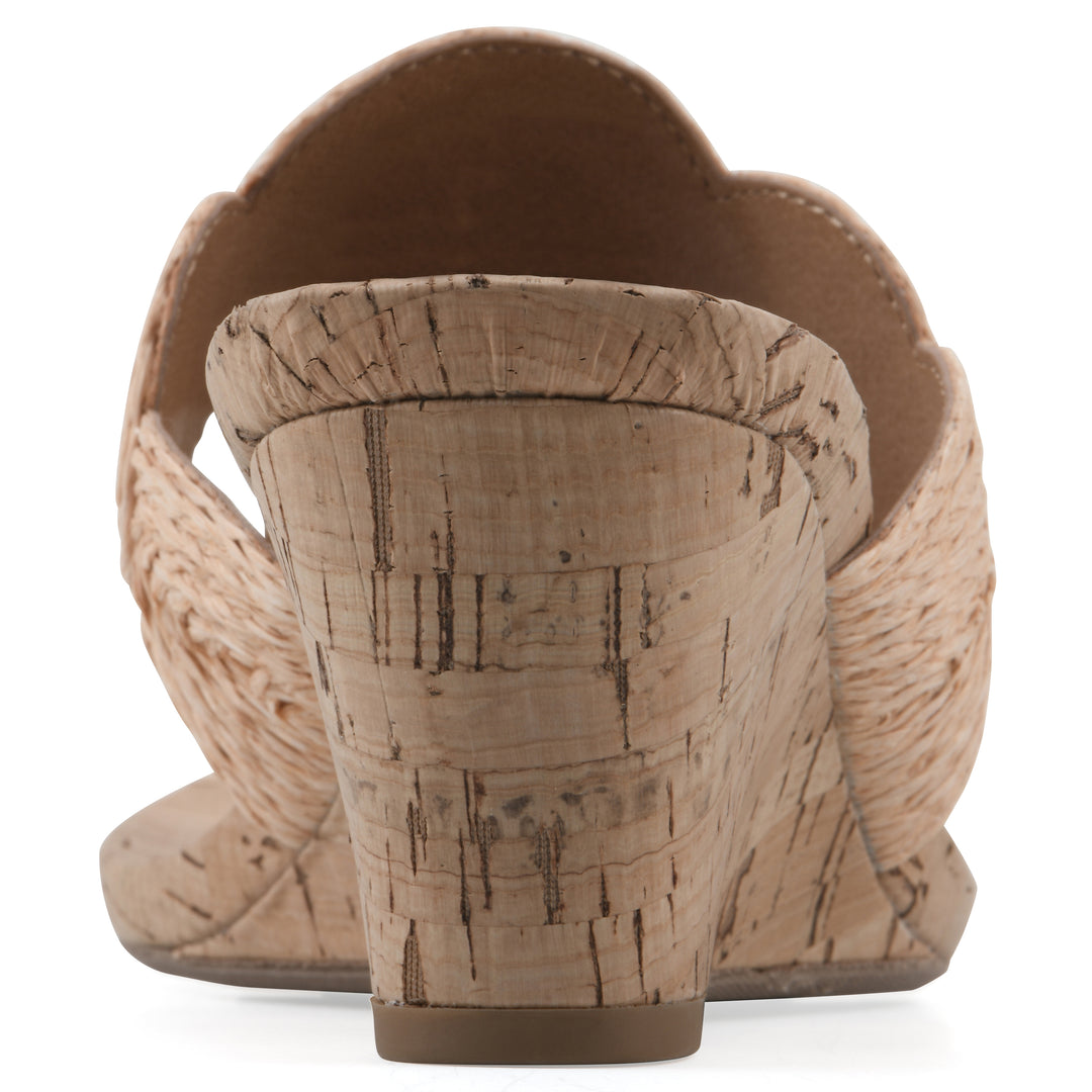 Rear view of a cork print wedge sandal with natural apricot color raffia thong design 