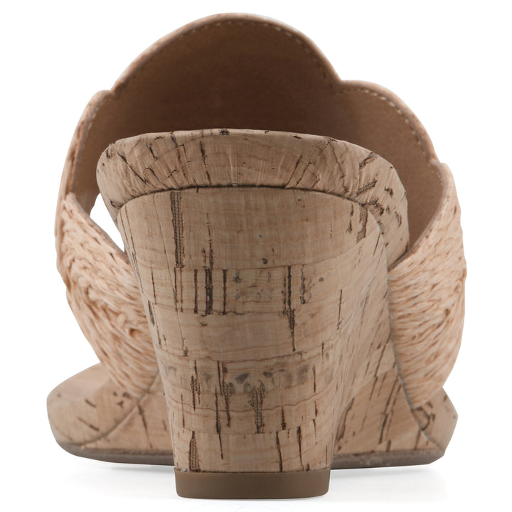 Rear view of a cork print wedge sandal with natural apricot color raffia thong design 