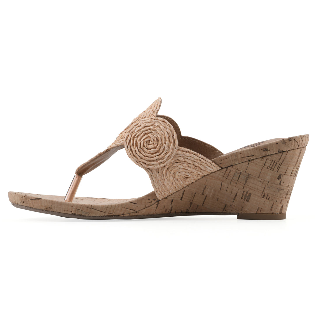Side view of a cork print wedge sandal with natural apricot color raffia thong design 