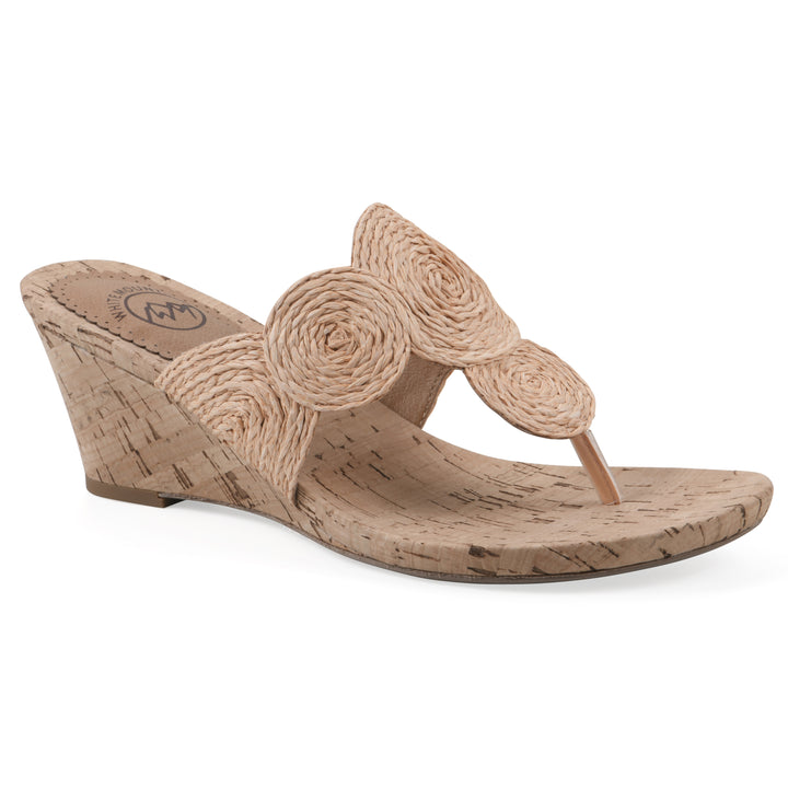 Angle view of a cork print wedge sandal with natural apricot color raffia thong design 
