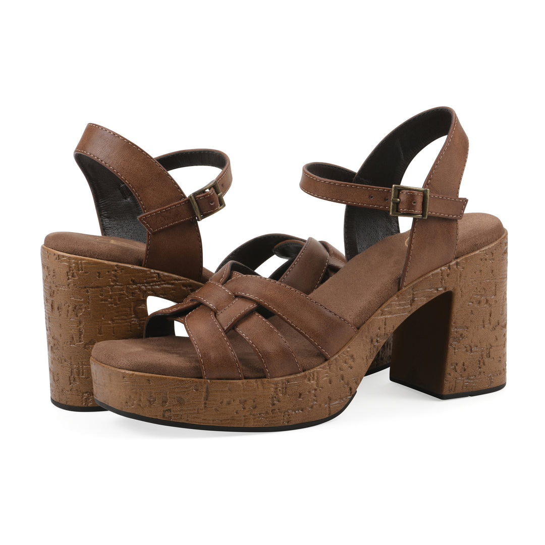 Angle view of a pair of brown faux leather platform sandals with buckle style ankle strap and a brown molded cork sole