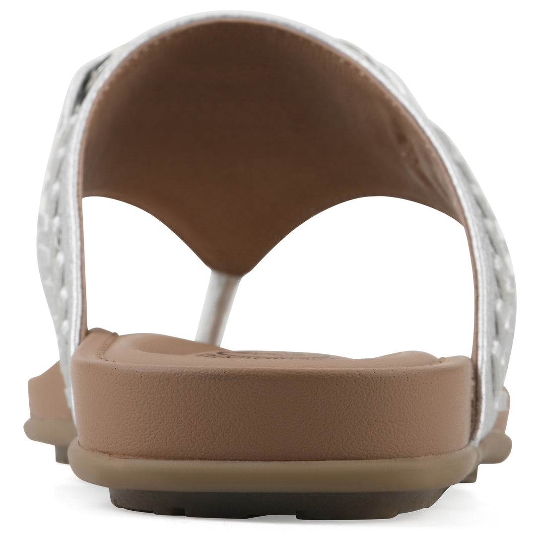 Rear view of a silver thong sandal with metal embellishment and a brown sole