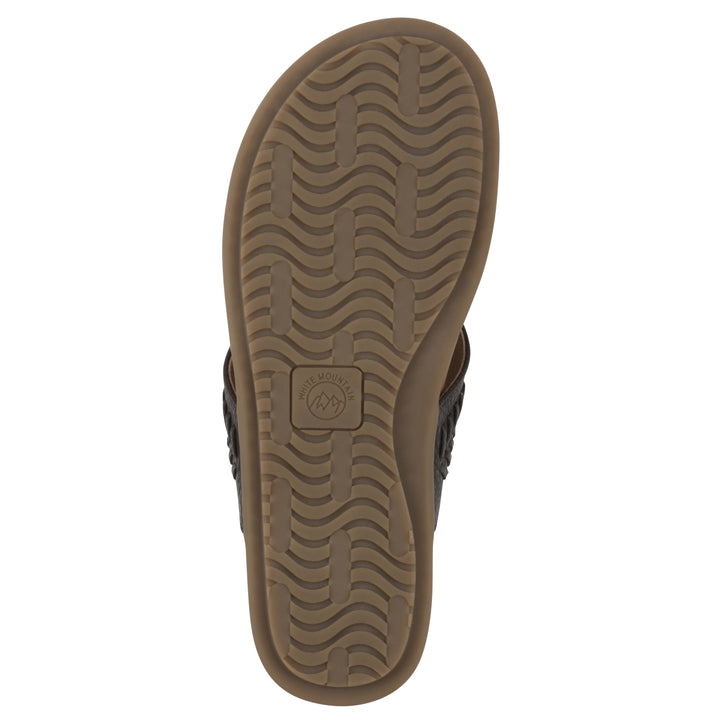 Sole view of a brown thong sandal with metal embellishment and a brown sole