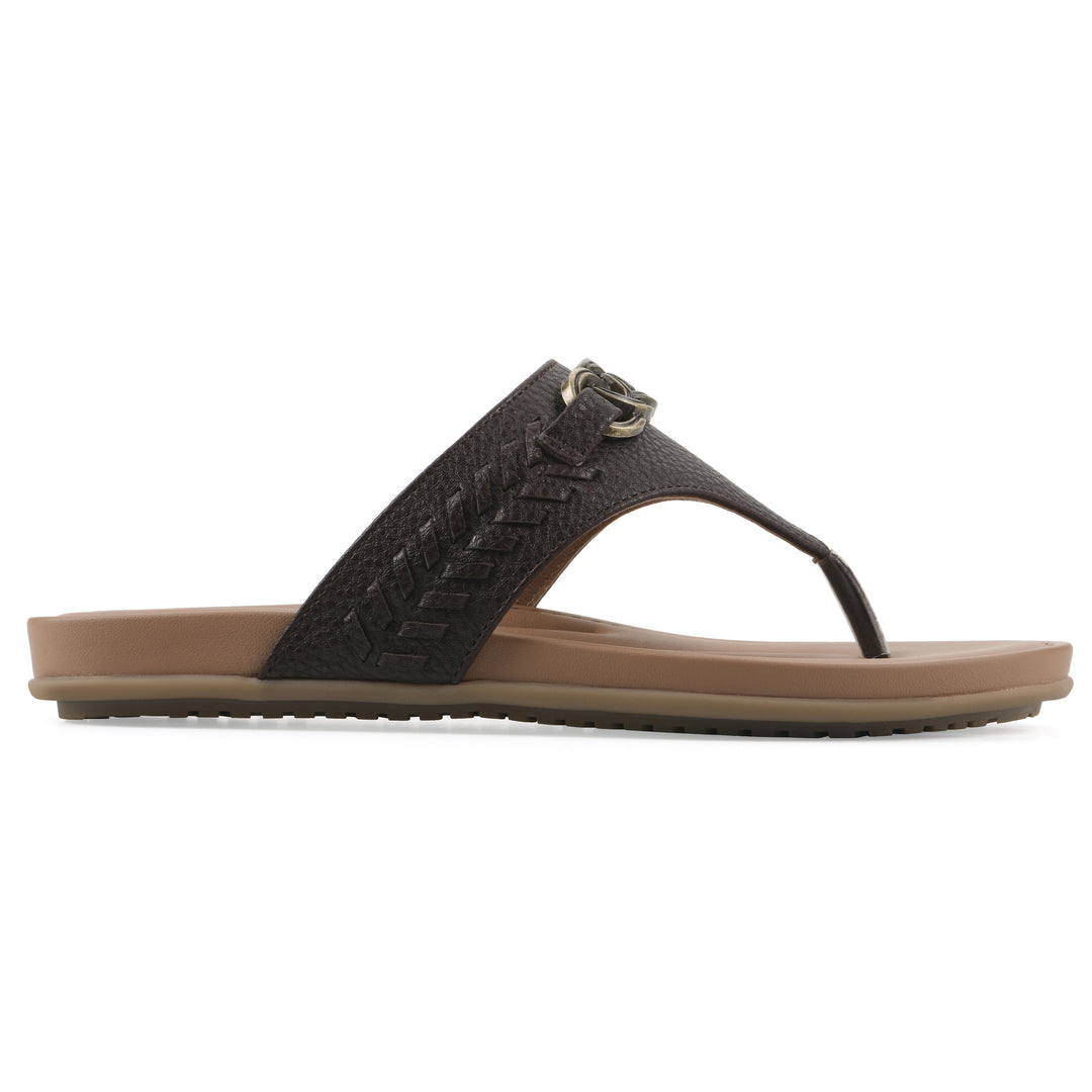 Side view of a brown thong sandal with metal embellishment and a brown sole