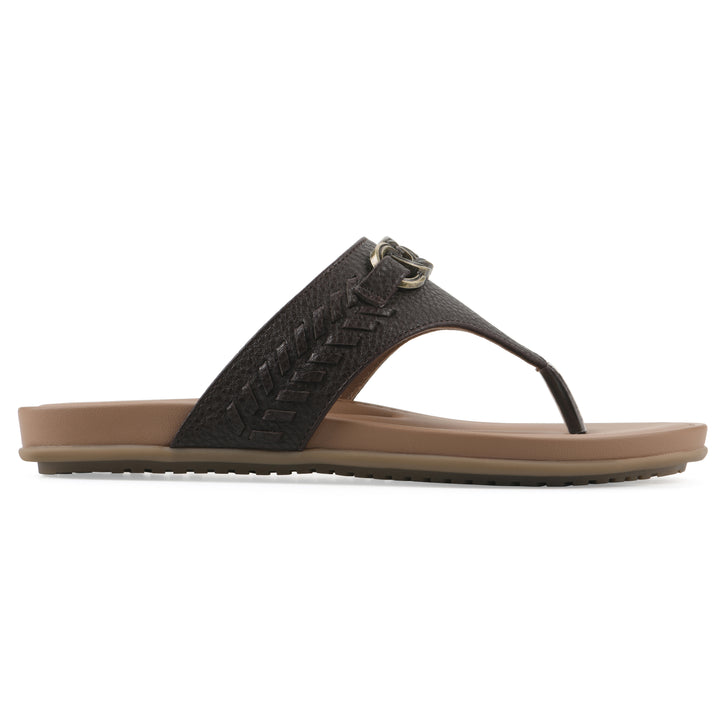 Side view of a brown thong sandal with metal embellishment and a brown sole