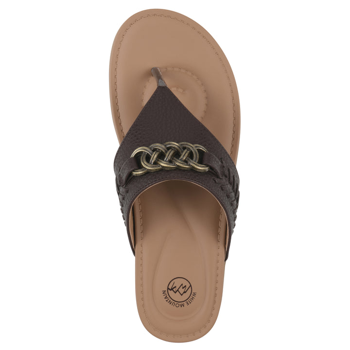 Top view of a brown thong sandal with metal embellishment and a brown sole