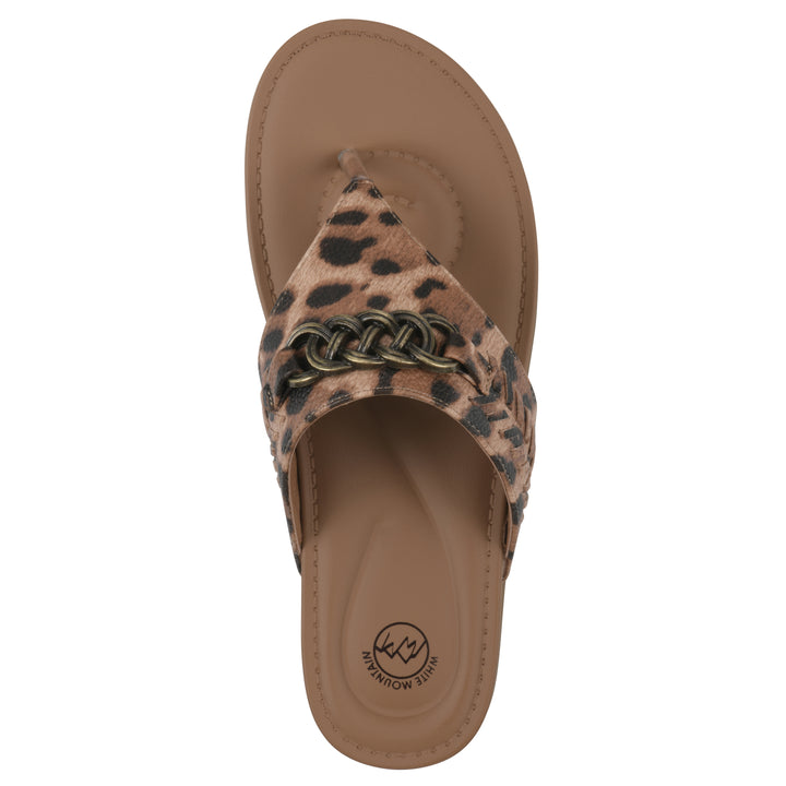 Top view of a leopard print thong sandal with metal embellishment and a brown sole