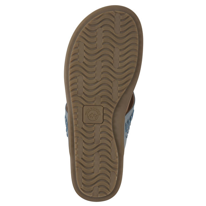 Sole view of a blue thong sandal with metal embellishment and a brown sole