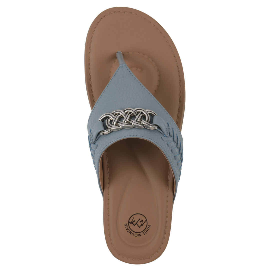 Top view of a blue thong sandal with metal embellishment and a brown sole