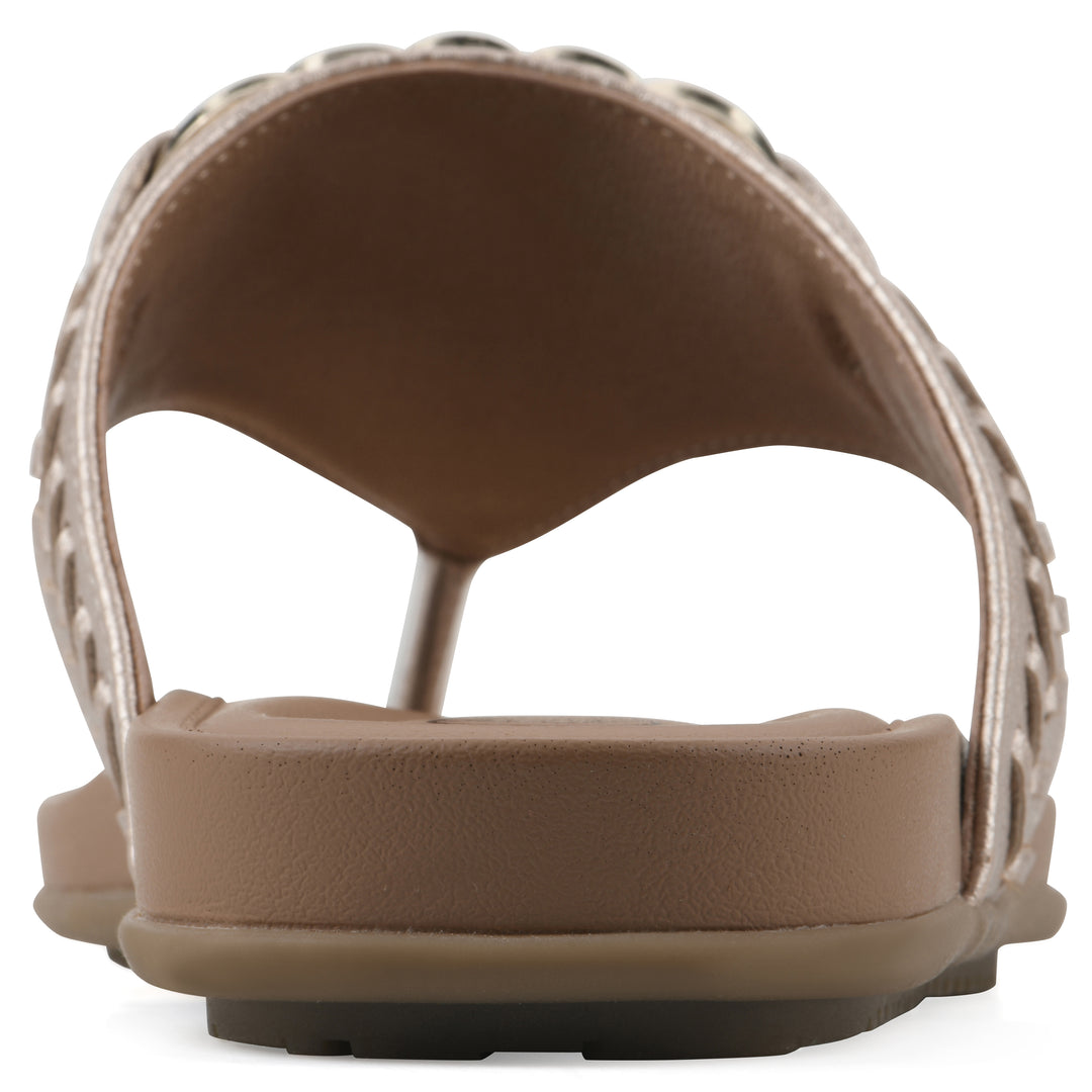 Rear view of a light gold thong sandal with metal embellishment and a brown sole