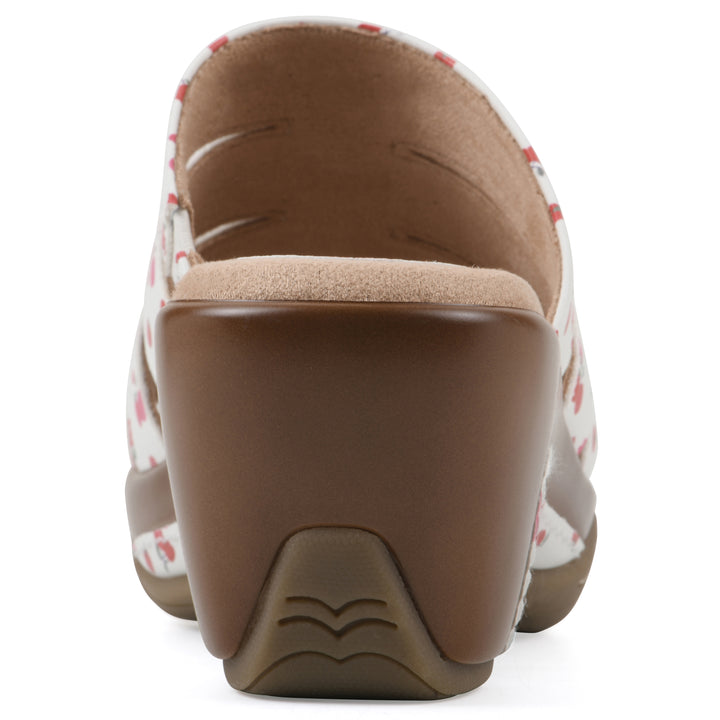 Rear view of an open-toe mule sandal in white with a red cherry pattern, a cushioned insole, and a brown heel 