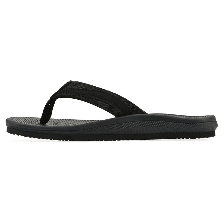 Side view of a cushioned black fabric thong sandal with black patterned sole