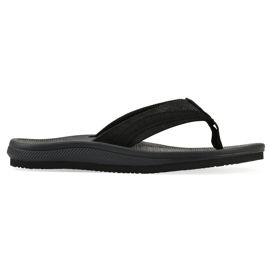 Side view of a cushioned black fabric thong sandal with black patterned sole
