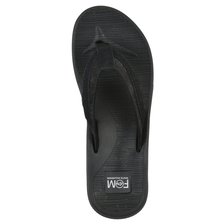 Top view of a cushioned black fabric thong sandal with black patterned sole