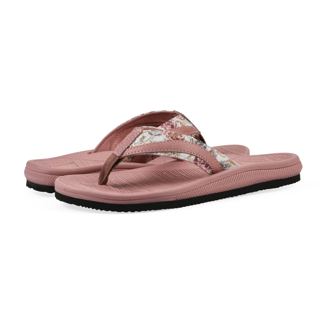 Angle view of a pair of cushioned pink floral thong sandals with pink patterned sole
