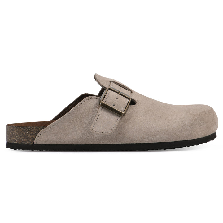 Side view of a taupe suede children's clog with metal buckle on an adjustable strap, and a brown sole with black bottom